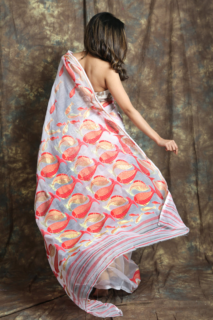 The White Color Saree Is Crafted With Red & Golden Zari Fish Motif Work All Over The Body And Pallu - Charukriti.co.in